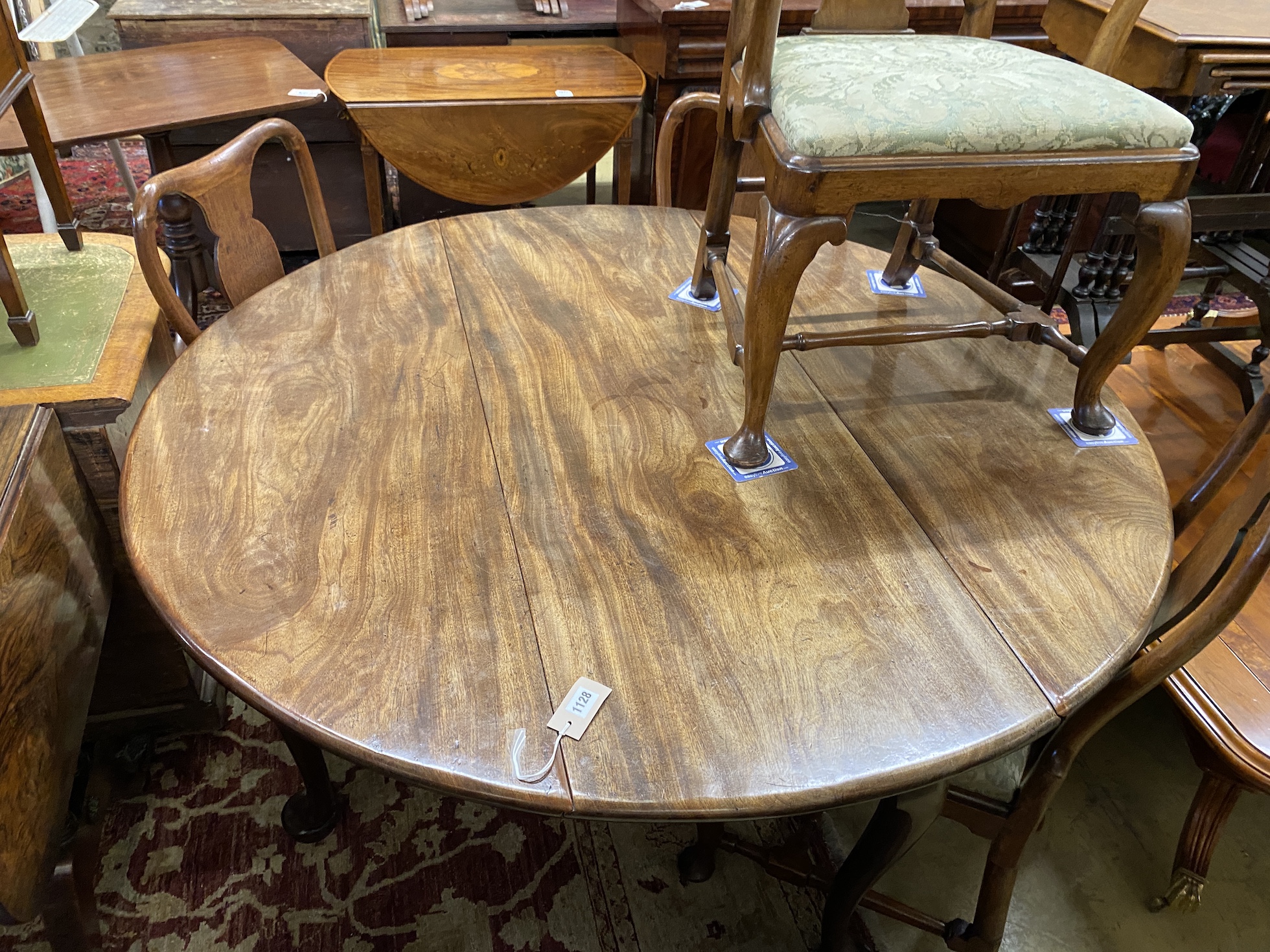 An 18th century circular mahogany drop leaf padfoot dining table, 140cm extended, height 70cm